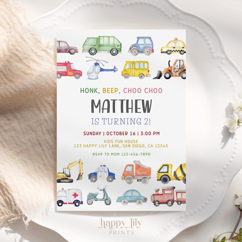 May include: A white invitation card with colorful watercolor illustrations of various vehicles, including cars, trucks, and a helicopter. The text reads "HONK, BEEP, CHOO CHOO" and announces "MATTHEW IS TURNING 2!" with event details.
