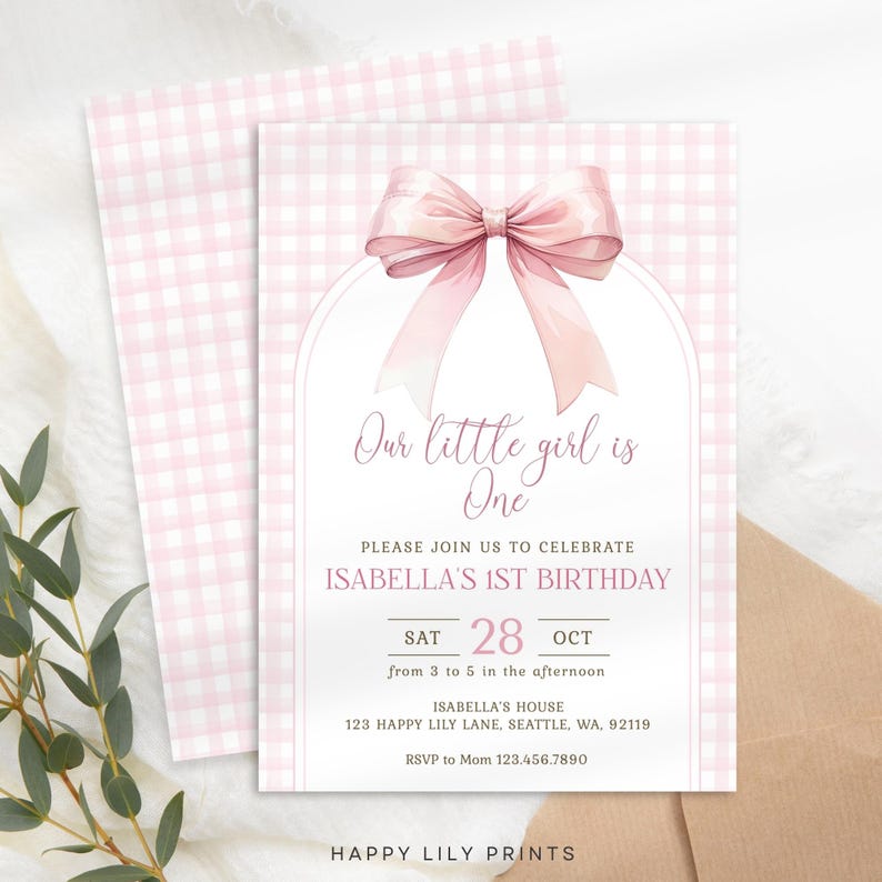 May include: Pink and white gingham patterned invitation with a large pink bow. The text reads "Our little girl is One. Please join us to celebrate Isabella's 1st Birthday. Sat 28 Oct from 3 to 5 in the afternoon. Isabella's House 123 Happy Lily Lane, Seattle, WA, 92119. RSVP to Mom 123.456.7890. Happy Lily Prints."