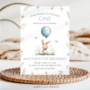 May include: A blue and white birthday invitation with a cute bunny holding a blue balloon. The invitation says "Some bunny is turning one" and "Matthew's 1st Birthday".