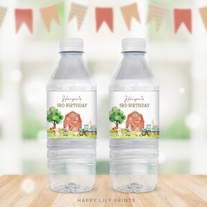 May include: Two clear plastic water bottles with personalized labels. The labels feature a watercolor illustration of a red barn, farm animals, and a tractor. The text on the labels reads "Harper's 3rd Birthday".
