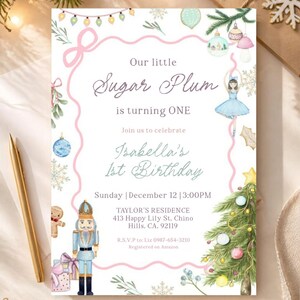May include: A white birthday invitation card featuring watercolour illustrations of a nutcracker, a ballerina, a Christmas tree, and ornaments. The text reads: Our little Sugar Plum is turning ONE, Isabella's 1st Birthday, Sunday, December 12, 3:00PM.