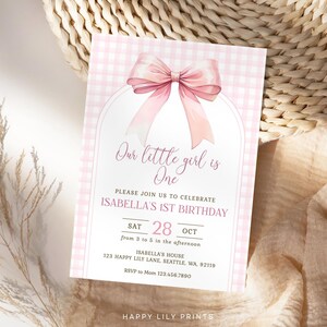 May include: Pink and white gingham patterned invitation with a large pink bow. The text reads "Our little girl is One. Please join us to celebrate Isabella's 1st Birthday. Sat 28 Oct from 3 to 5 in the afternoon. Isabella's House 123 Happy Lily Lane, Seattle, WA, 92119. RSVP to Mom 123.456.7890. Happy Lily Prints."