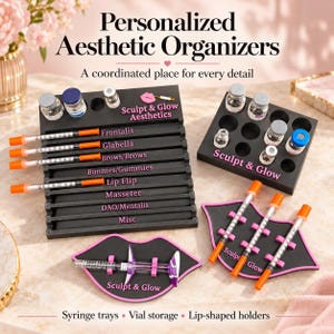 May include: A set of black organizers for aesthetic supplies, including a tiered syringe tray with labels like Frontalis and Lip Flip, a vial storage block, and two lip-shaped holders. All pieces feature pink text reading Sculpt & Glow.