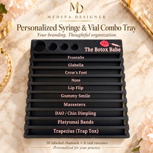 May include: A black rectangular organizer tray featuring four circular vial recesses at the top and ten horizontal channels labeled with text including Frontalis, Glabella, Crow's Feet, Nose, Lip Flip, Gummy Smile, Masseters, DAO, and Trapezius.