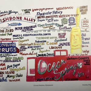 May include: A colorful hand-drawn illustration of Ocean Springs, Mississippi. The illustration features a red truck with the words "Ocean Springs" written on the side. The illustration also includes a variety of landmarks and businesses in Ocean Springs, such as the "Fishbone Alley", "The Shed", "Lovelace Drugs", "Shearwater Pottery", "The Roost Hotel", and "Mississippi's Secret Coast".