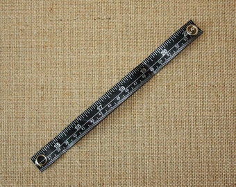 Tape Measure Bracelet in Black - Statement Jewelry created with Upcycled Measuring Tape - Vinyl Snap Bracelet - Crafty Repurposed Trashion