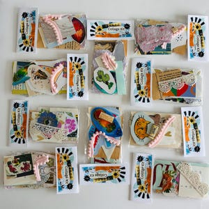 May include: Arrangement of collage kits, each containing assorted paper ephemera, lace, and embellishments. The kits are packaged in clear plastic and labeled with "Collage Kit" stickers. The kits include a variety of colors and textures.