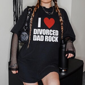 May include: Black oversized t-shirt with a red heart and the text "I ♥ Divorced Dad Rock".