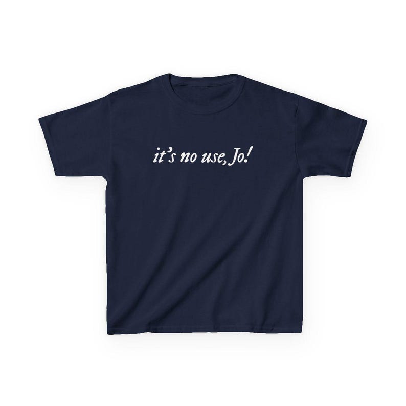 May include: Navy blue t-shirt with the white text "it's no use, Jo!" printed across the chest. The short-sleeved shirt is made of a soft material and is suitable for casual wear.
