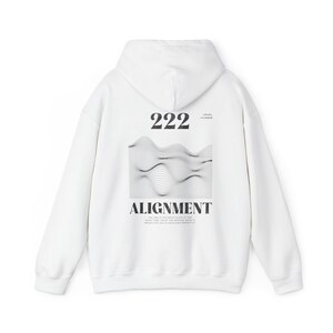 May include: White hooded sweatshirt with a black graphic print on the back. The graphic features the number 222, the words "Angel Number" and "Alignment", and a wavy line design.
