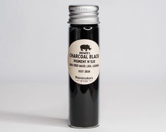 May include: A small glass bottle with a silver lid filled with black charcoal pigment. The label reads "Brewer's Charcoal Black Pigment N'020 Anai Ober Ward, Lira, Uganda July 2024 Paintmakers of Lira".