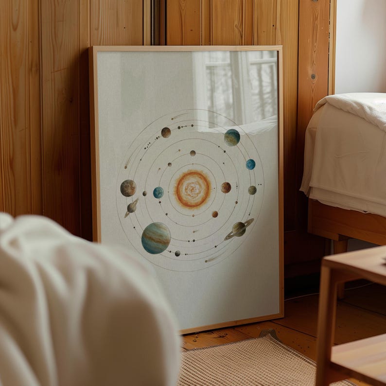 May include: A framed print featuring a watercolor illustration of the solar system. The artwork depicts the sun at the center, surrounded by planets of various colors and sizes, with circular orbits. The frame is made of light-colored wood.