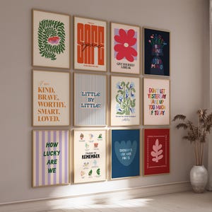 May include: A set of framed art prints with motivational quotes and floral illustrations. The prints display a range of colours, including orange, blue, and red, with text such as "Be Kind to Your Mind" and "How Lucky Are We".