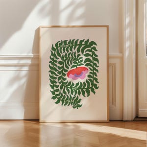 May include: A framed art print with the text "GROWTH IS NOT LINEAR." The artwork features a red and pink floral shape at the center, surrounded by a green leafy border. The background is a light beige color.
