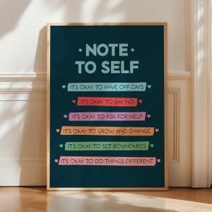 May include: A teal blue poster with the text "• NOTE. TO SELF" in white. The poster has six colourful strips with the text "IT'S OKAY TO HAVE OFF DAYS", "IT'S OKAY TO SAY NO", "IT'S OKAY TO ASK FOR HELP", "IT'S OKAY TO GROW AND CHANGE", "IT'S OKAY TO SET BOUNDARIES", and "IT'S OKAY TO DO THINGS DIFFERENT".