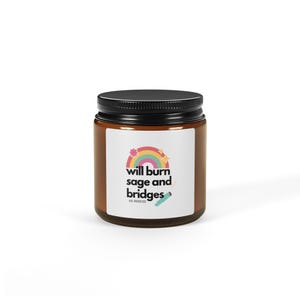 May include: A brown glass candle jar with a black lid. The label has a rainbow with stars and the text "will burn sage and bridges as needed".