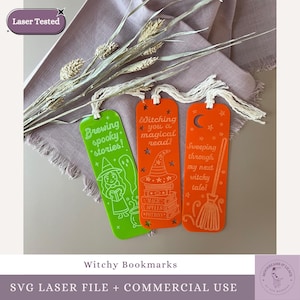 May include: Three witchy-themed bookmarks in green and orange. The green bookmark says "Brewing spooky stories!" with a witch illustration. The orange bookmarks say "Witching you a magical read!" and "Sweeping through my next witchy tale!"