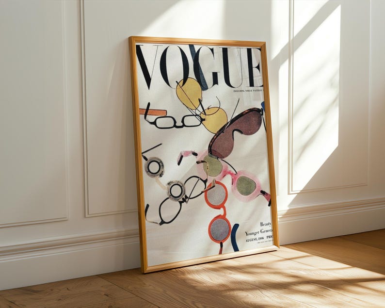 May include: A framed Vogue magazine cover featuring the magazine's logo in black and a colorful illustration of eyeglasses. The frame is a light wood color, and the magazine is leaning against a white wall. Vogue Sunglasses Collage Art Print | Minimalist Fashion Wall Decor (Instant Digital Download)