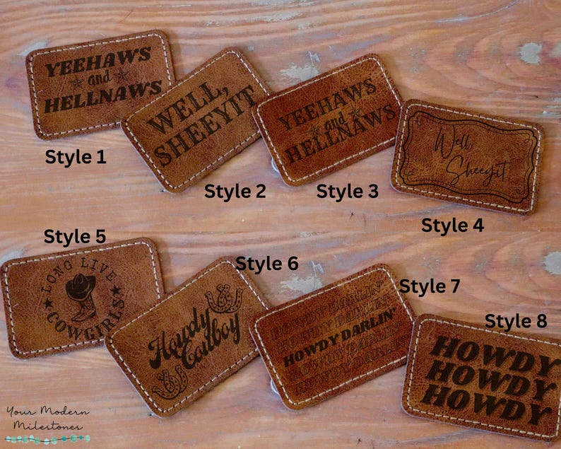 May include: Eight different styles of leather patches with various western-themed sayings and designs. The patches are brown and have a stitched edge. The sayings include "Yeehaws and Hellnaws", "Well, Sheeyit", "Long Live Cowgirls", "Howdy Cowboy", "Howdy Darlin", and "Howdy Howdy Howdy".