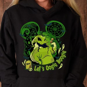 May include: Black hooded sweatshirt featuring a green graphic of Oogie Boogie from The Nightmare Before Christmas. The design includes a Mickey Mouse ear silhouette, a haunted house, and the text "Let's Oogie Boogie".