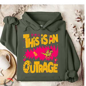May include: Olive green hoodie with the text "THIS IS AN OUTRAGE" in yellow, with a pink background. The design includes a cartoon character riding a dinosaur. A fun and quirky graphic sweatshirt.