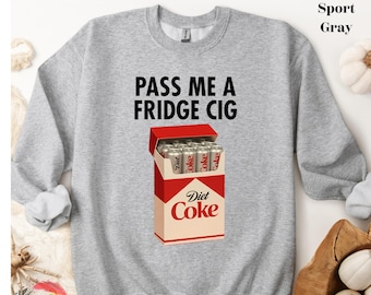 May include: Sport gray sweatshirt with the text "PASS ME A FRIDGE CIG". The graphic shows a Diet Coke box with Diet Coke cans inside. The sweatshirt is a crew neck style.