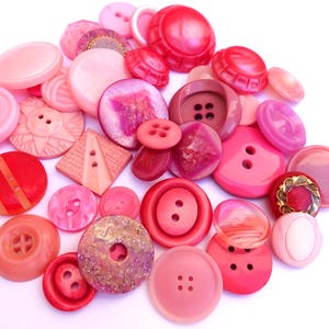39 Buttons, antique and vintage plastic pink to red violet shades buttons, assorted shapes and shades