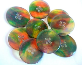 May include: A collection of eight round, multi-colored buttons with a swirl pattern. The buttons are made of a translucent material and have four holes each.