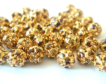 6 cuentas de cristal Swarovski vintage: forma de bola marrón, chapadas en oro (10 mm)