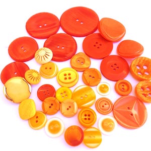 33 Buttons, antique and vintage plastic deep yellow to orange shades buttons, assorted shapes and shades