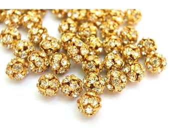 6 cuentas Swarovski vintage de 8 mm con cristales engastados en metal color oro, formando una bola.