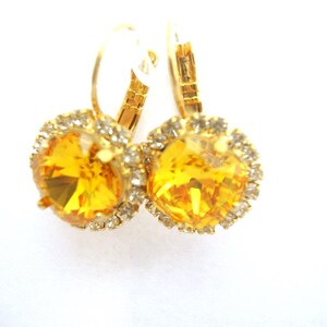 Earrings made of Swarovski crystals embedded in gold plated setting, yellow crystal