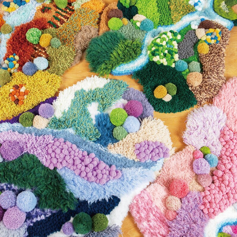 May include: Close-up of colorful, fluffy, handmade rugs with various textures and pom-poms. The rugs are made in a variety of colors, including pink, blue, green, and yellow.