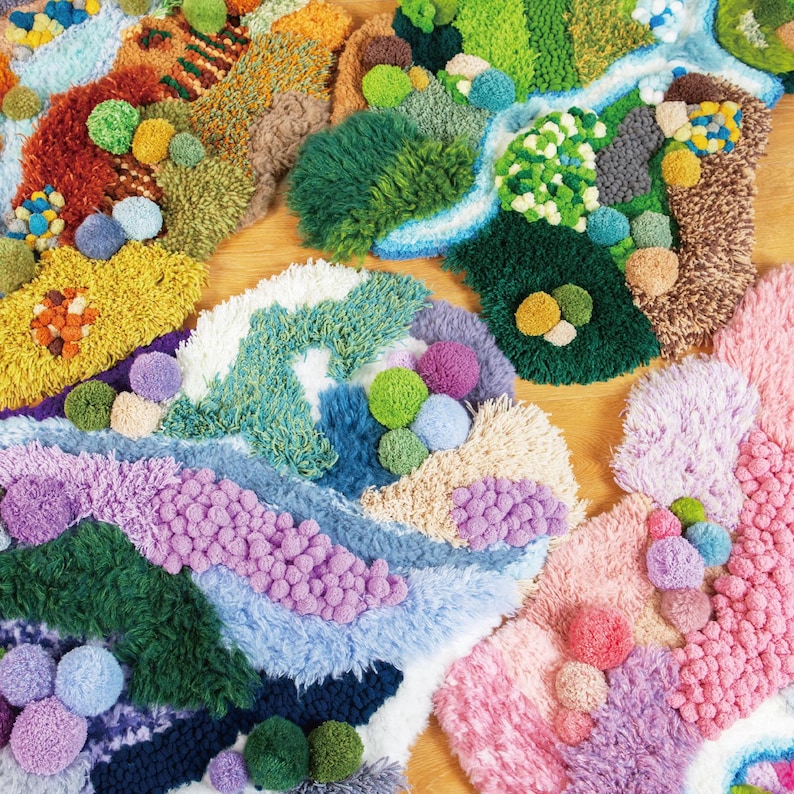 May include: A collection of colorful, textured textile art pieces. The pieces feature a variety of colors, including green, blue, pink, purple, and yellow, with raised textures and pom-pom accents. The designs appear to be abstract, with organic shapes and patterns.
