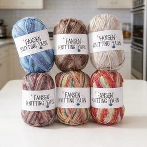 May include: Six skeins of FANSEN Knitting Yarn in various colors, including blue, brown, and multicolored options. Each skein has a white label with the brand name. The yarn is arranged in two stacks of three.