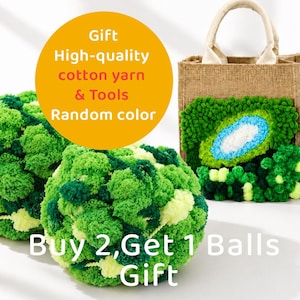 May include: A burlap tote bag featuring a green, blue, and white pom-pom kiwi design, accompanied by two large spheres of green-toned yarn. The text reads: Gift High-quality cotton yarn & Tools Random color and Buy 2, Get 1 Balls Gift.