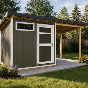 May include: A dark green shed with a black roof and white trim. The shed has a window and a door with a glass panel. A wooden pergola extends from the shed, and it sits on a concrete patio. The shed is surrounded by a green lawn and trees.