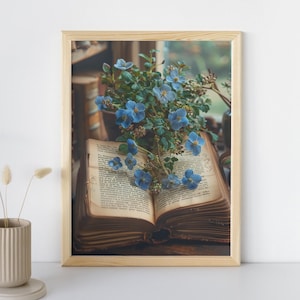 May include: An open book with aged pages lies on a wooden surface, adorned with a bouquet of delicate blue flowers. The flowers are arranged artfully, creating a sense of tranquility and beauty.