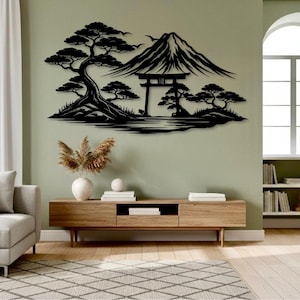 May include: Black metal wall art depicting a Japanese landscape with Mount Fuji, trees, and a torii gate. The artwork is mounted on a light green wall above a wooden media console. The room has a modern, minimalist aesthetic.
