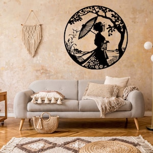 May include: A gray couch with a throw blanket and pillows sits in a living room with a wooden side table, a woven basket, and a floor lamp. A black metal wall decor featuring a woman with an umbrella and flowers is on the wall behind the couch.