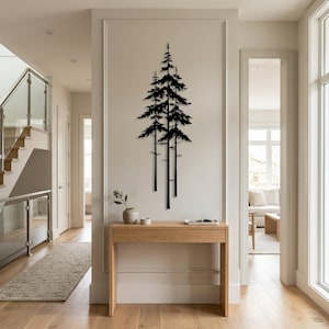 May include: A black metal wall art piece depicting three stylized pine trees. The artwork is mounted on a white wall in a well-lit hallway. A wooden console table with decorative items sits below the art.