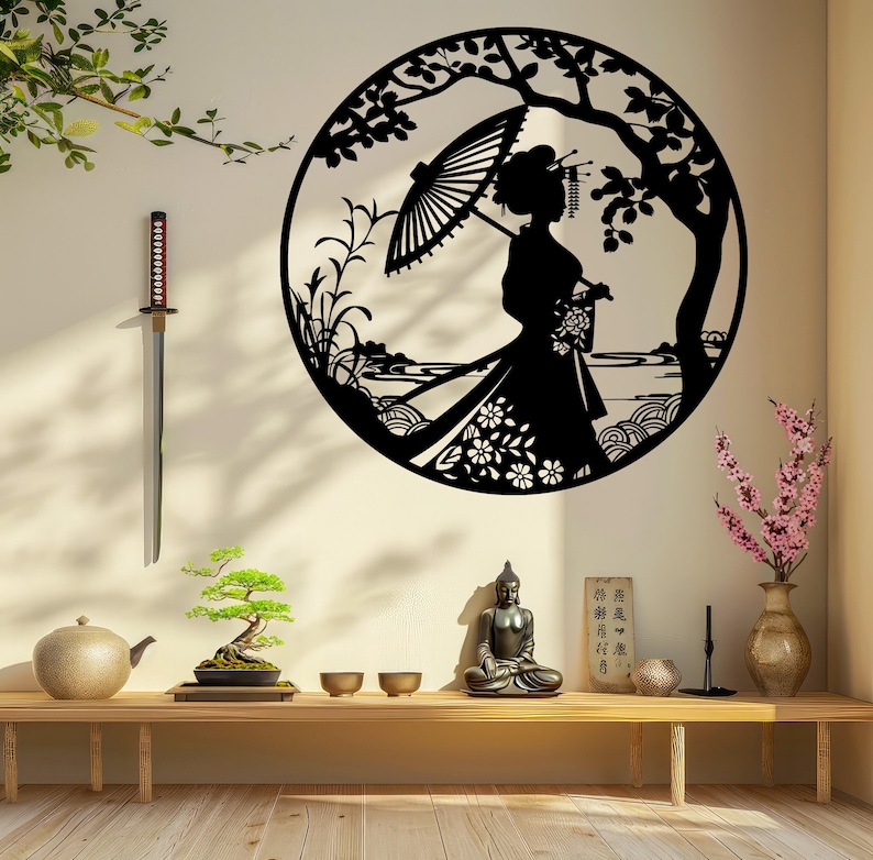 May include: Black metal wall art depicting a woman in a traditional Japanese kimono holding an umbrella, standing in a garden setting with flowers and trees. The art is circular and has a delicate, intricate design.