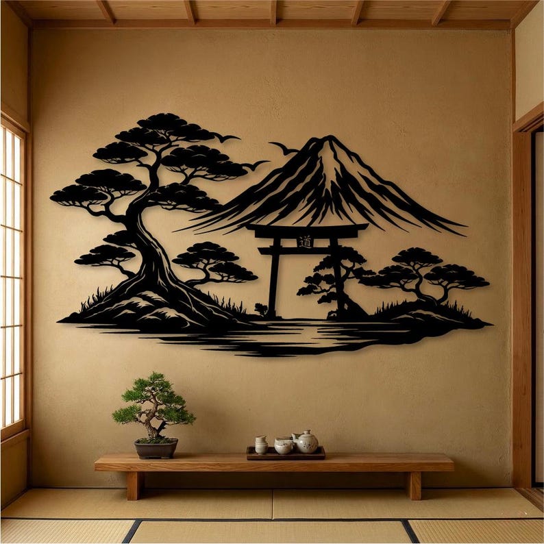 May include: Black metal wall art depicting a Japanese landscape with a mountain, trees, and a traditional gate. The artwork is mounted on a beige wall, with a wooden bench and bonsai tree in the foreground. The scene evokes a sense of tranquility.