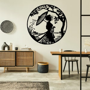 May include: Black metal wall art depicting a woman in a traditional Japanese kimono holding an umbrella, standing under a tree with flowers and leaves. The art is circular and has a detailed design.