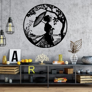 May include: Black metal wall art featuring a silhouette of a woman with an umbrella standing in a garden setting. The art is displayed on a gray wall above a black shelf with various decorative items.