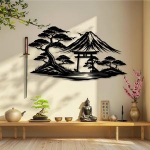 May include: A black metal wall art piece depicting a Japanese landscape with a mountain, trees, and a traditional gate. A katana hangs on the wall. A wooden bench holds a bonsai tree, teapot, bowls, a Buddha statue, and a vase with pink flowers.