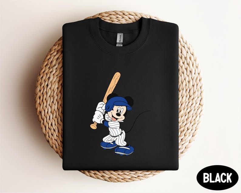 a mickey mouse t - shirt with a baseball bat on it