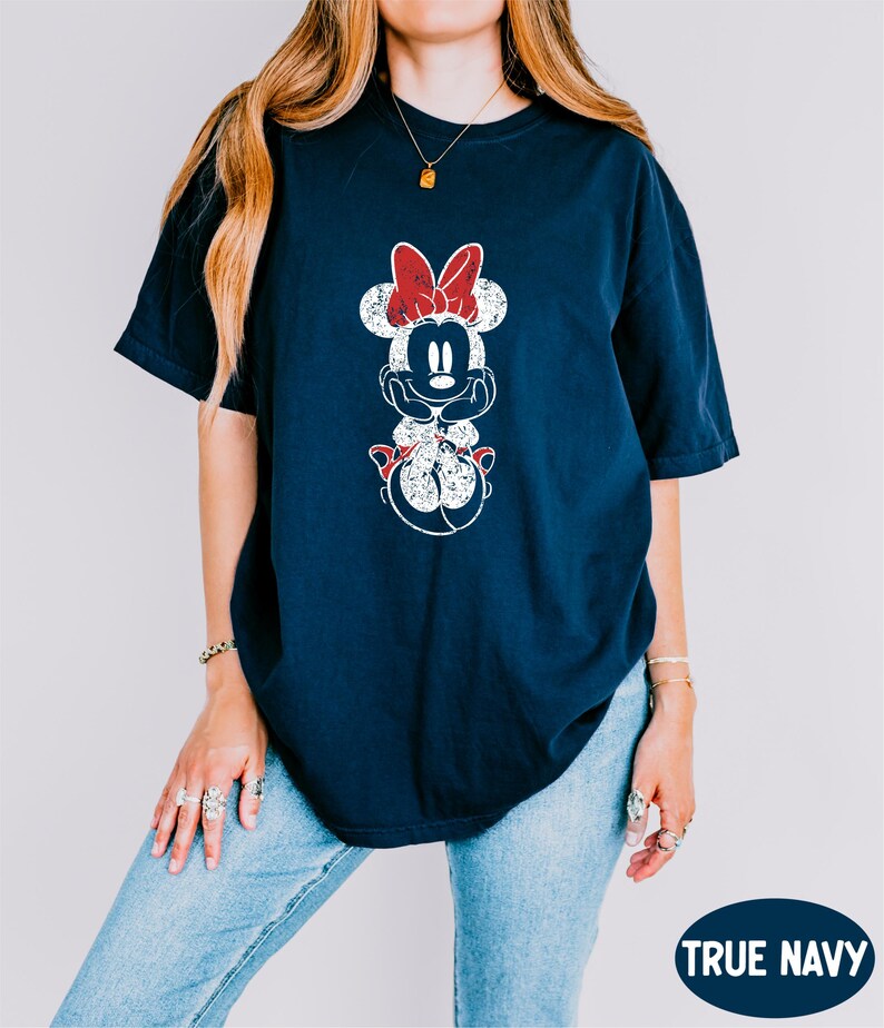 a woman wearing a mickey mouse t - shirt