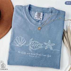 a blue t - shirt with a sea turtle on it