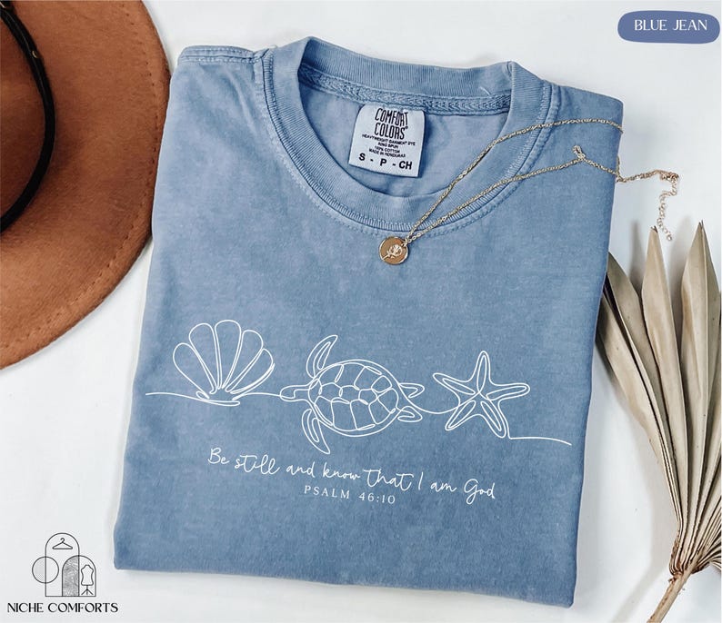 a blue t - shirt with a sea turtle on it